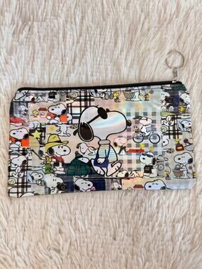 Snoopy pencil case with multiple poses and outfits on a plaid background black